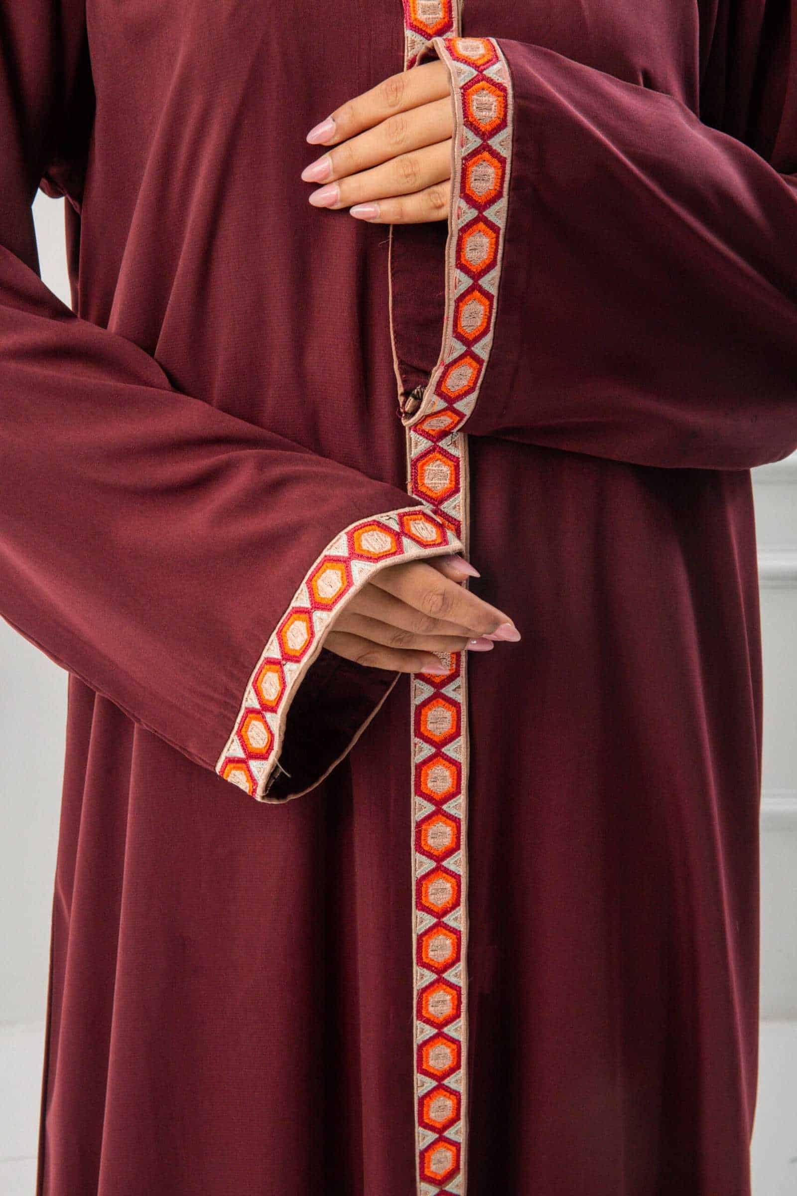 woman showing the work and emroidy of abaya