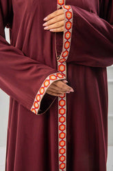 woman showing the work and emroidy of abaya