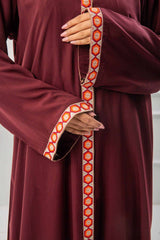 woman showing the work and emroidy of abaya