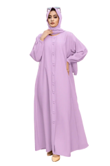 Woman in elegant lilac hijab and long dress standing confidently