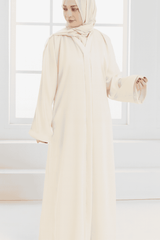 woman standing next to the window with an elegant abaya style