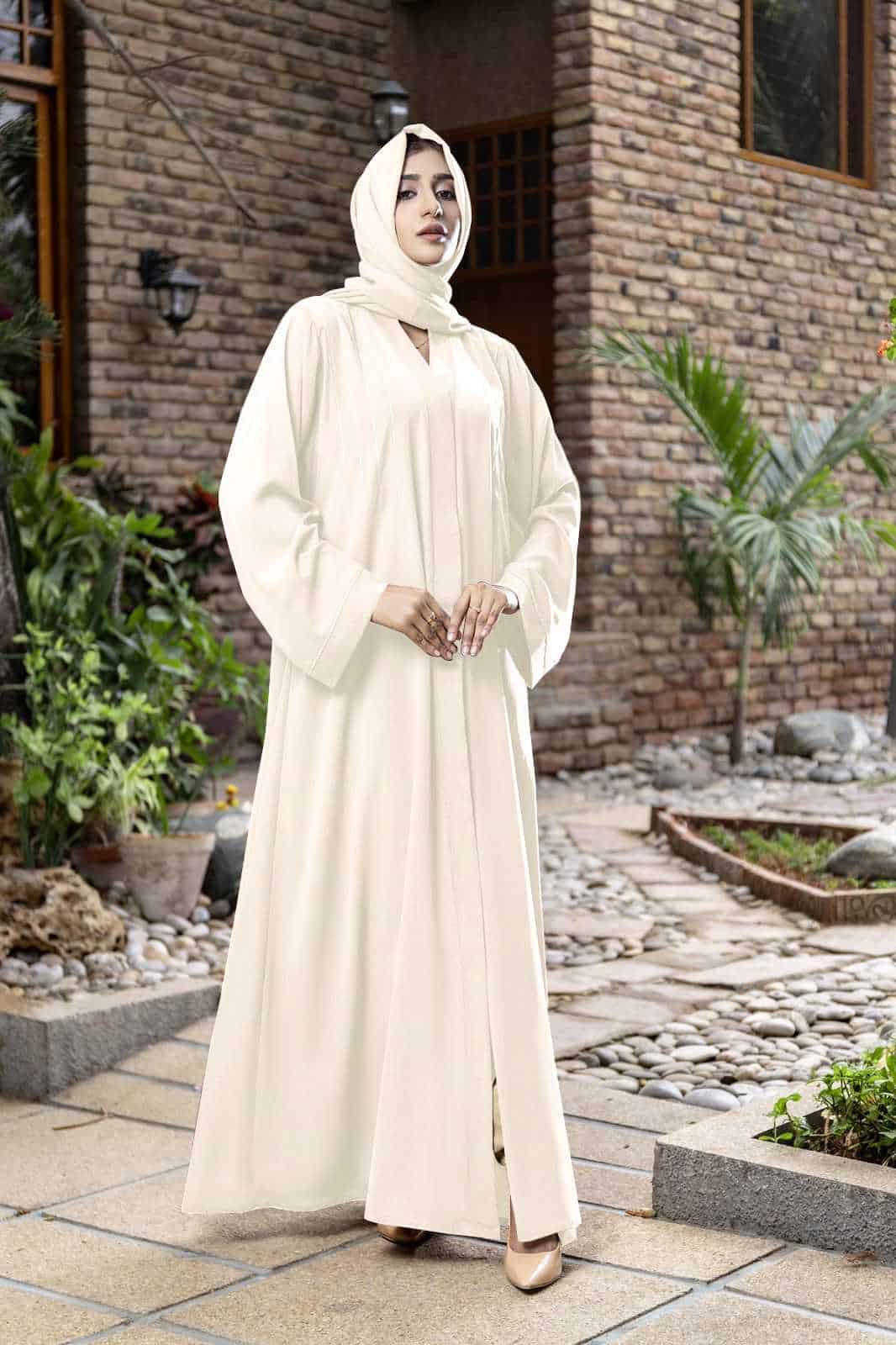 hijabi model with beige abaya posing outdoor