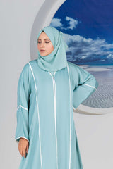 Woman in stylish blue abaya with scenic beach window view