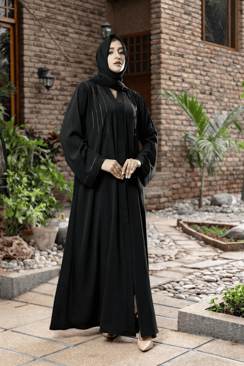 woman wearing black abaya standing in an area surrounded by plants